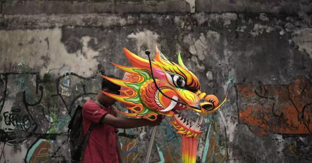 AP PHOTOS: Indonesia welcomes the Year of the Snake with dragon puppets and drum displays