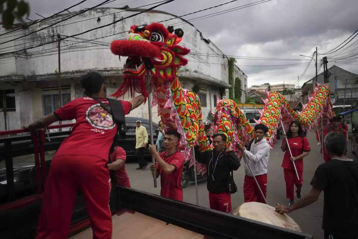 Members of dragon dance club Naga Merah Putih (Red White Dragon) which named after Indonesian national colors, carry a dragon puppet onto a truck as they prepare to leave for a shopping mall to perform in a Lunar New Year celebration, in Bogor, West Java, Indonesia, Sunday, Jan. 26, 2025. (AP Photo/Dita Alangkara)