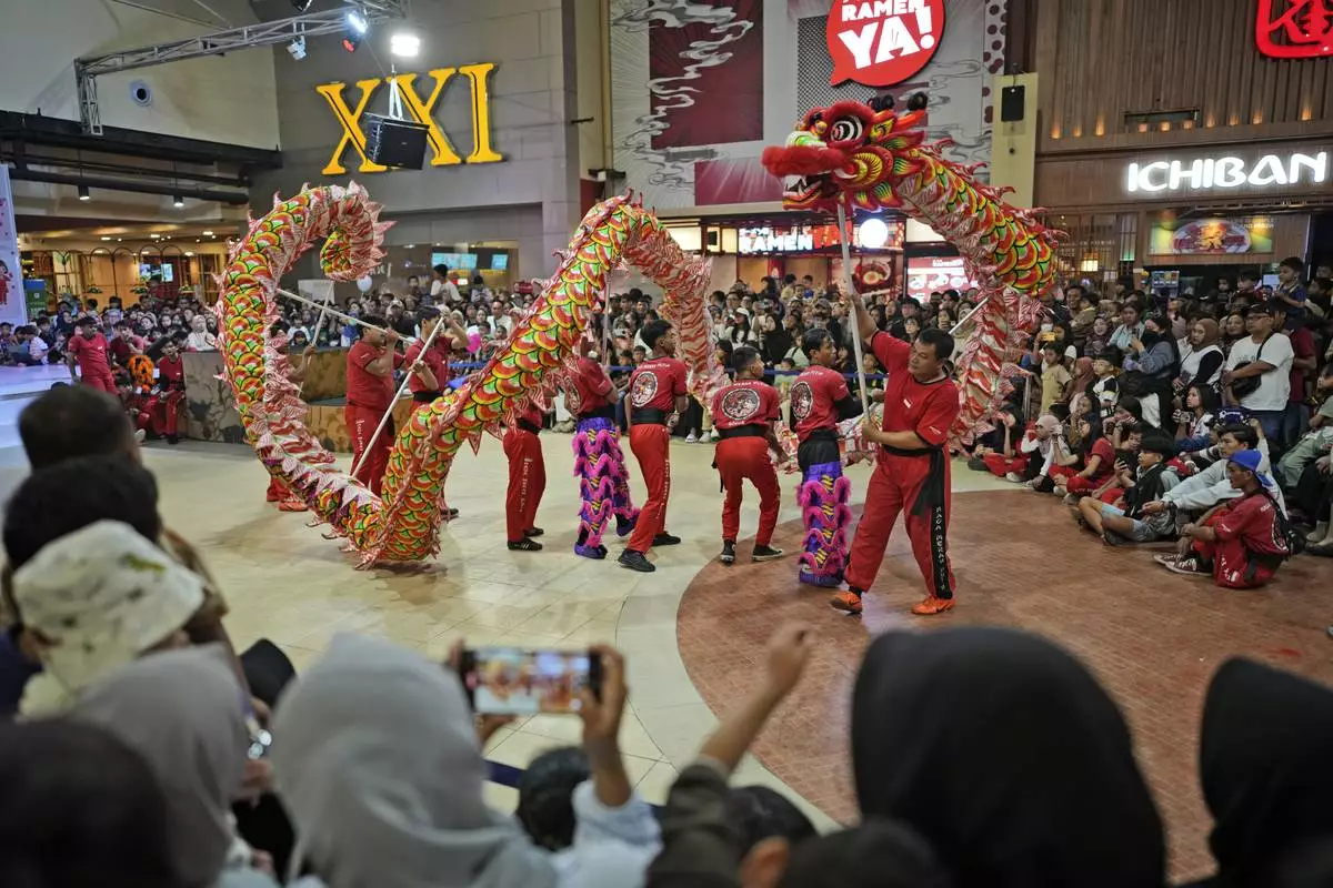 Members of dragon dance club Naga Merah Putih (Red White Dragon) which is named after Indonesian national colors, perform in a Lunar New Year celebration at a shopping mall in Bogor, West Java, Indonesia, Sunday, Jan. 26, 2025. (AP Photo/Dita Alangkara)