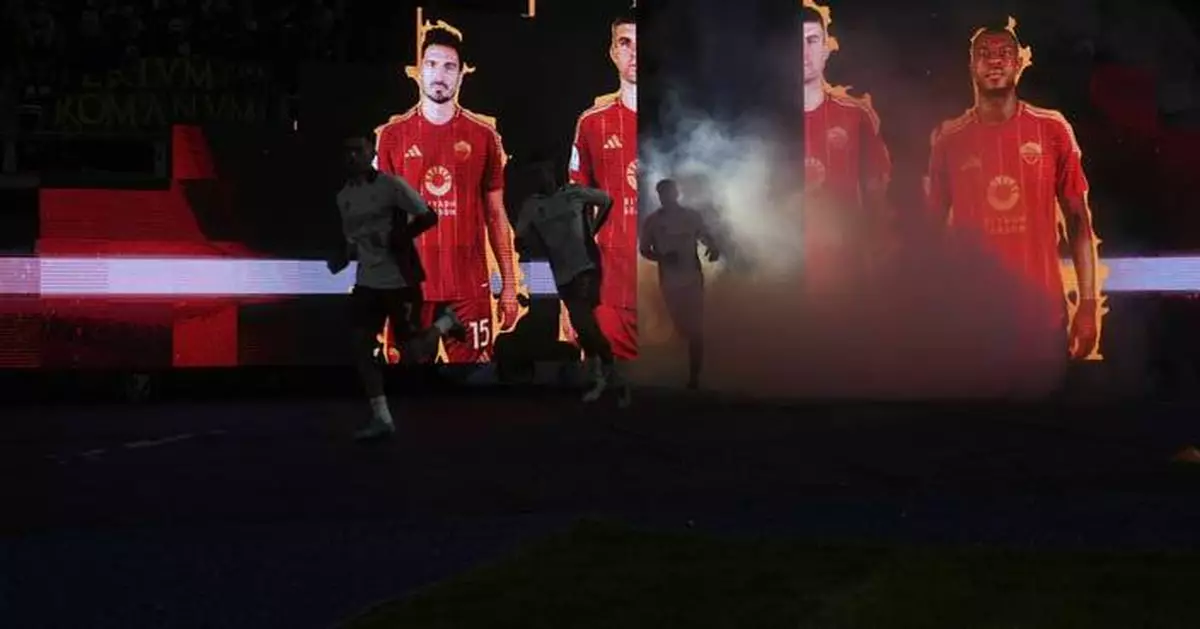 Car lit up in flames outside the stadium before Rome derby as rival fans approach each other