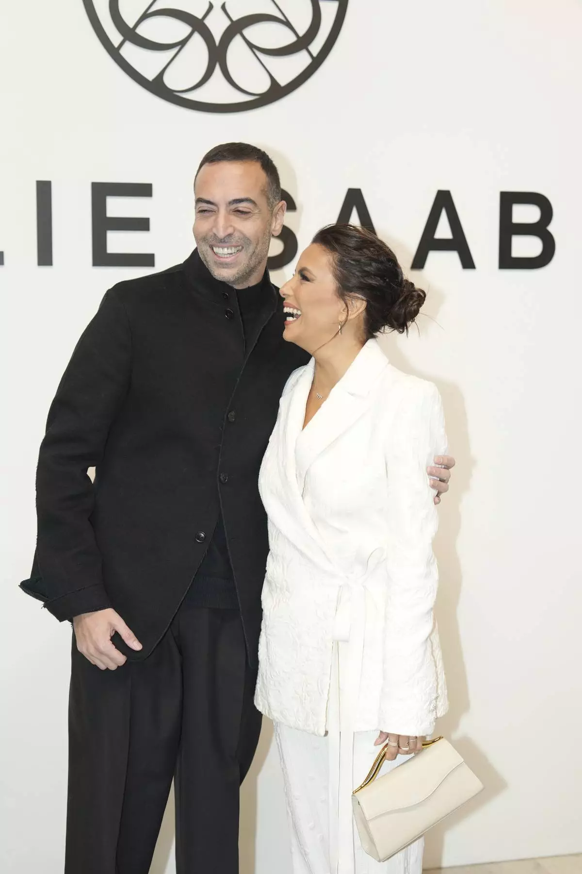 Eva Longoria and Mo Al Turk pose before Elie Saab Haute Couture Spring Summer 2025 collection, that was presented in Paris, Wednesday, Jan. 29, 2025. (AP Photo/Lewis Joly)
