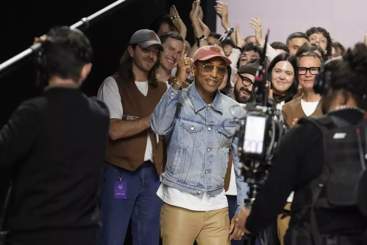 Pharrell Williams reacts after the men's Louis Vuitton Fall-Winter 2025-2026 collection, that was presented in Paris, Tuesday, Jan. 21, 2025. (AP Photo/Michel Euler)