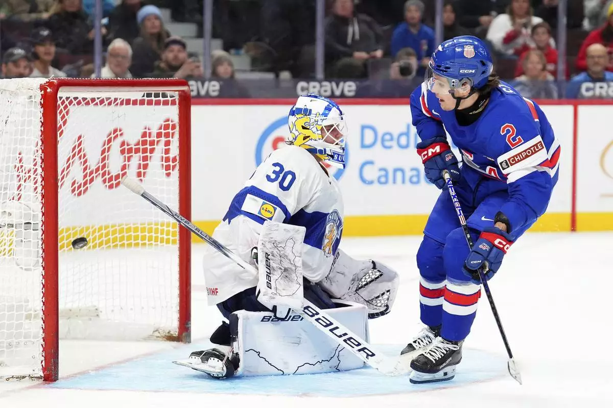 United States’ forward Teddy Stiga (2) scores the game-winning goal on Finland goaltender Petteri Rimpinen (30) to end overtime the IIHF World Junior Hockey Championship gold medal game in Ottawa, Ontario, Sunday, Jan. 5, 2025. (Sean Kilpatrick/The Canadian Press via AP)