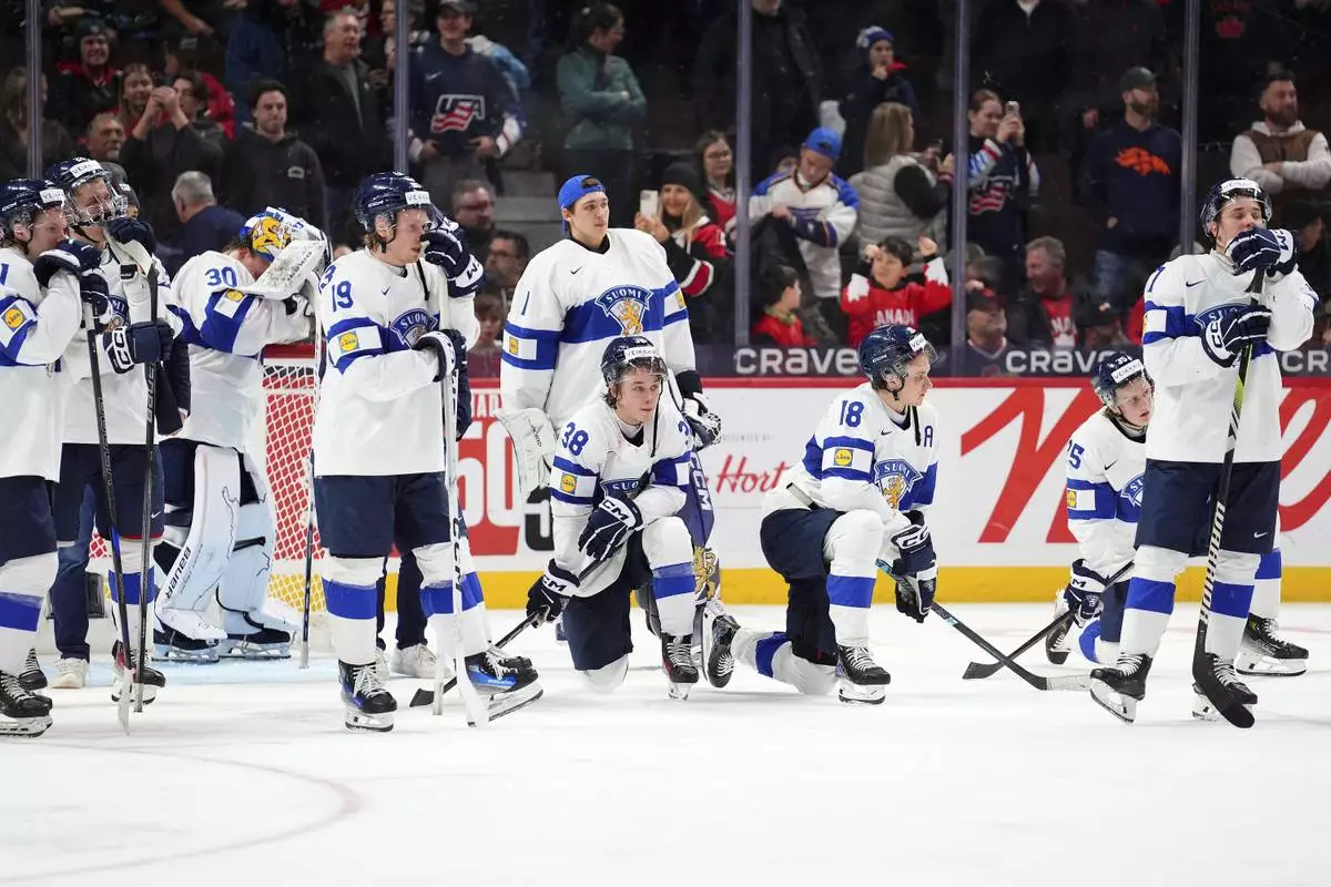 Finland players react following their overtime loss in the IIHF World Junior Hockey Championship gold medal game against the United States in Ottawa, Ontario, Sunday, Jan. 5, 2025. (Sean Kilpatrick/The Canadian Press via AP)
