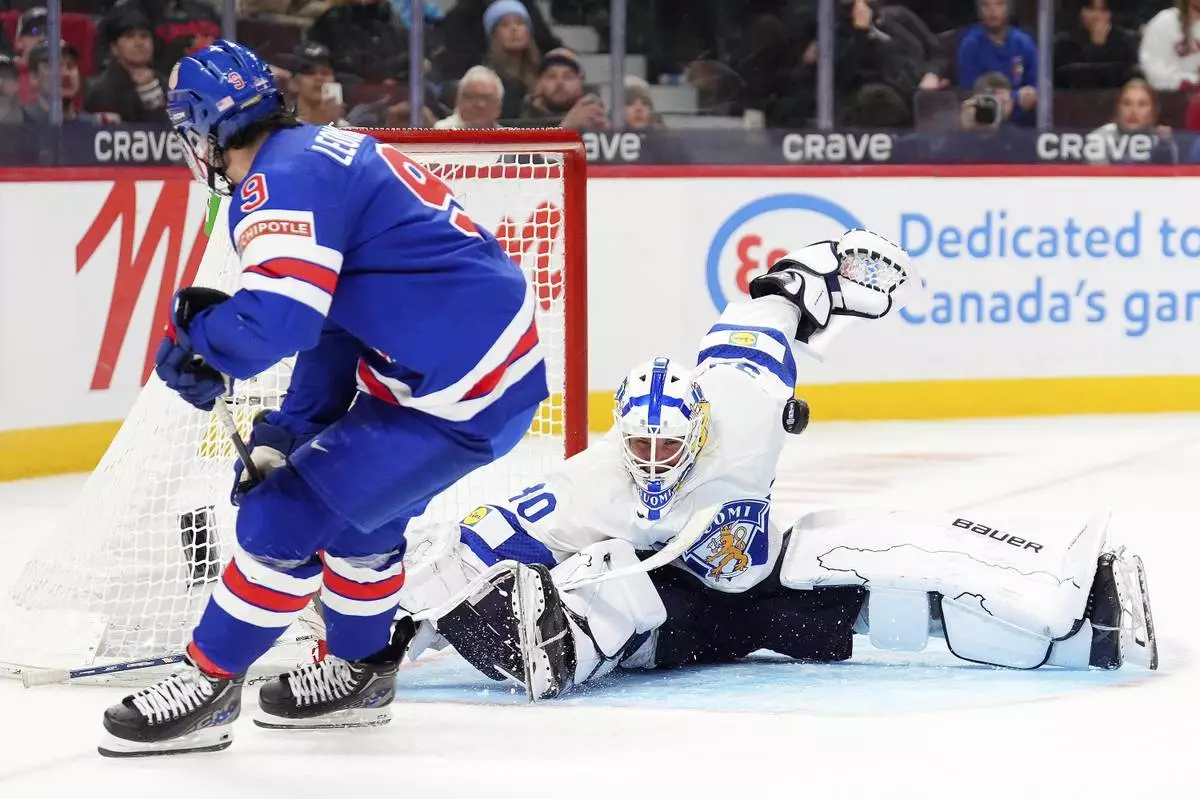 Finland goaltender Petteri Rimpinen (30) makes a save against United States forward Ryan Leonard (9) during third-period IIHF World Junior Hockey Championship gold medal game action in Ottawa, Ontario, Sunday, Jan. 5, 2025. (Sean Kilpatrick/The Canadian Press via AP)