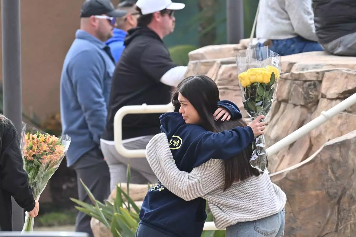 People attend a vigil at First Christian Church in Huntington Beach, Calif., on Friday, Jan. 3, 2025, for those killed in a small plane crash taking off from the Fullerton Municipal Airport the day before. (Jeff Gritchen/The Orange County Register via AP)