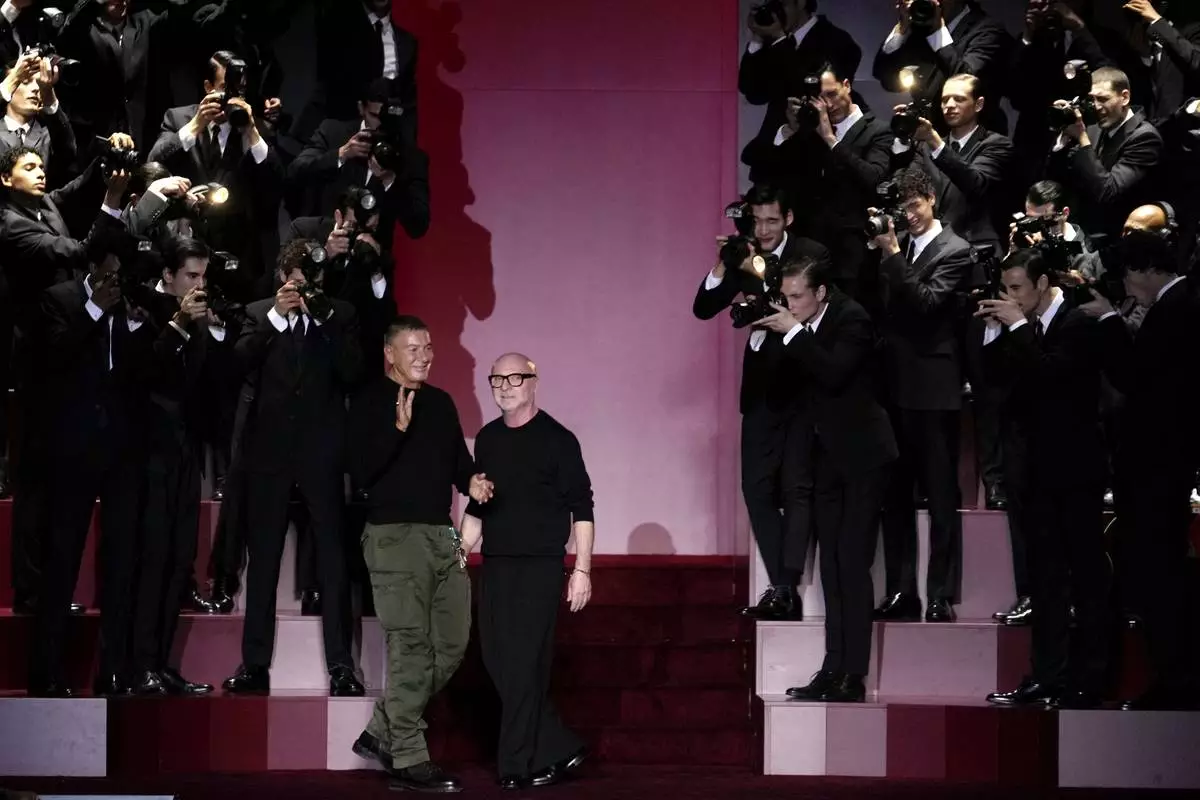 Designers Stefano Gabbana, left, and Domenico Dolce accept applause after the men's Dolce &amp; Gabbana Fall-Winter 2025-2026 collection show, that was presented in Milan, Italy, Saturday, Jan. 18, 2025. (AP Photo/Luca Bruno)