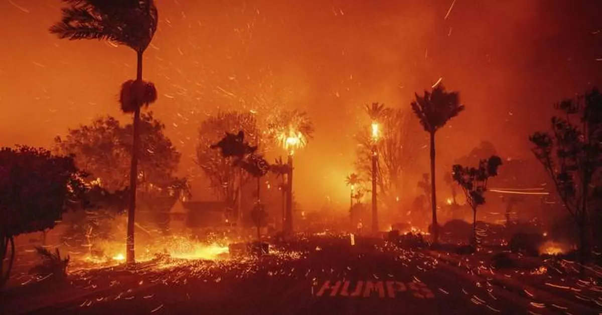 Wildfires burn out of control across Los Angeles area and kill 2 as thousands flee homes