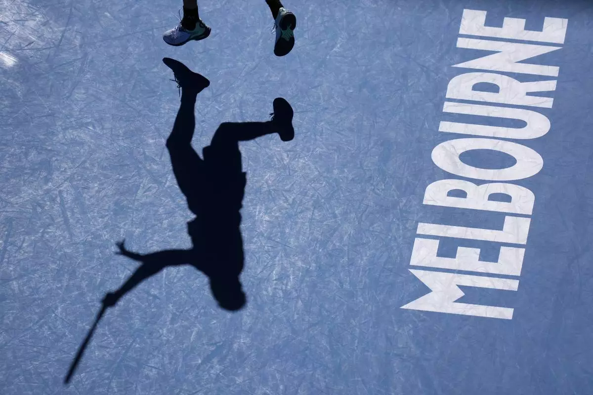 Lorenzo Sonego of Italy serves to Ben Shelton of the U.S. during their quarterfinal match at the Australian Open tennis championship in Melbourne, Australia, Wednesday, Jan. 22, 2025. (AP Photo/Vincent Thian)