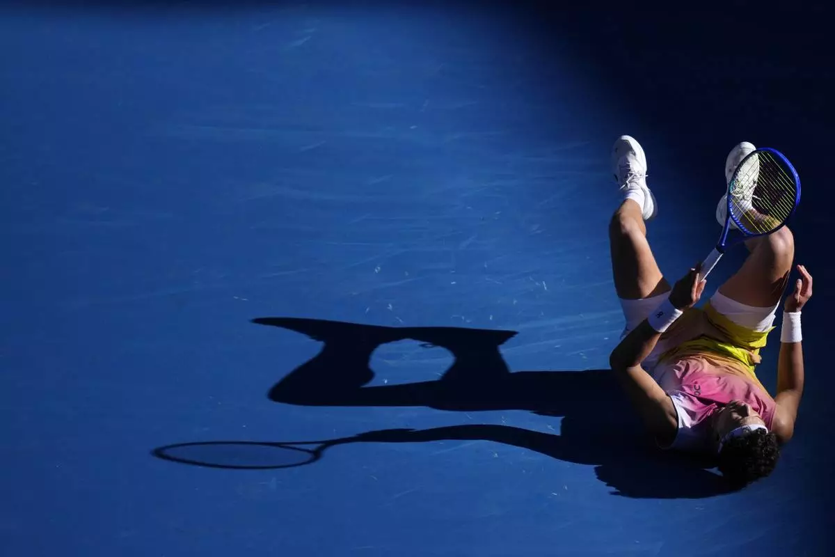 Ben Shelton of the U.S. falls during his quarterfinal match against Lorenzo Sonego of Italy at the Australian Open tennis championship in Melbourne, Australia, Wednesday, Jan. 22, 2025. (AP Photo/Vincent Thian)