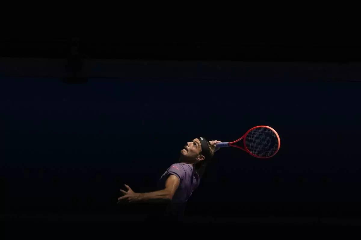 Taylor Fritz of the U.S. serves to Gael Monfils of France during their third round match at the Australian Open tennis championship in Melbourne, Australia, Saturday, Jan. 18, 2025. (AP Photo/Manish Swarup)