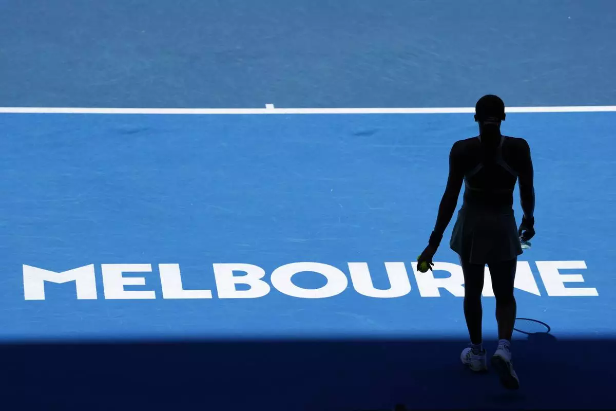 Coco Gauff of the U.S. prepares to serve to Paula Badosa of Spain during their quarterfinal match at the Australian Open tennis championship in Melbourne, Australia, Tuesday, Jan. 21, 2025. (AP Photo/Vincent Thian)