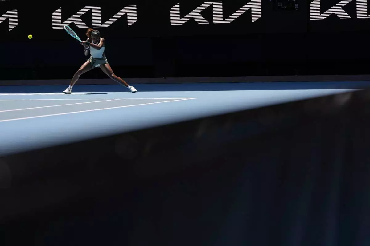 Coco Gauff of the U.S. returns a shot from Belinda Bencic of Switzerland during their fourth round match at the Australian Open tennis championship in Melbourne, Australia, Sunday, Jan. 19, 2025. (AP Photo/Asanka Brendon Ratnayake)