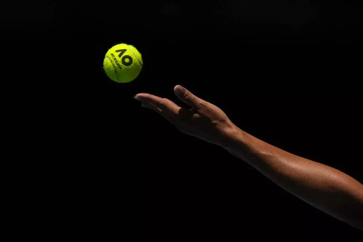 Iga Swiatek of Poland serves to Emma Navarro of the U.S. during their quarterfinal match at the Australian Open tennis championship in Melbourne, Australia, Wednesday, Jan. 22, 2025. (AP Photo/Asanka Brendon Ratnayake)