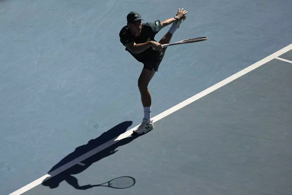Tommy Paul of the U.S. plays a forehand return to Alexander Zverev of Germany during their quarterfinal match at the Australian Open tennis championship in Melbourne, Australia, Tuesday, Jan. 21, 2025. (AP Photo/Ng Han Guan)