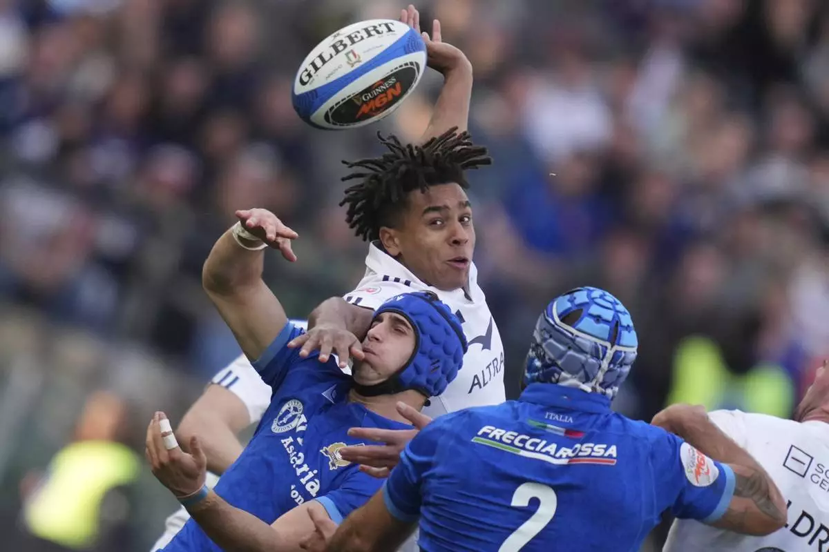 France's Mickael Guillard and Italy's Simone Gesi vie for the ball, during the Six Nations rugby union match between Italy and France at the Olympic stadium, in Rome, Sunday, Feb. 23, 2025. (Alfredo Falcone/LaPresse via AP)