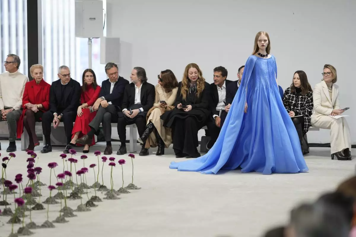 Carolina Herrera, second from left, looks on as a model walks the runway during the Carolina Herrera Fall/Winter 2025 fashion show as part of New York Fashion Week on Monday, Feb. 10, 2025, in New York. (Photo by Charles Sykes/Invision/AP)