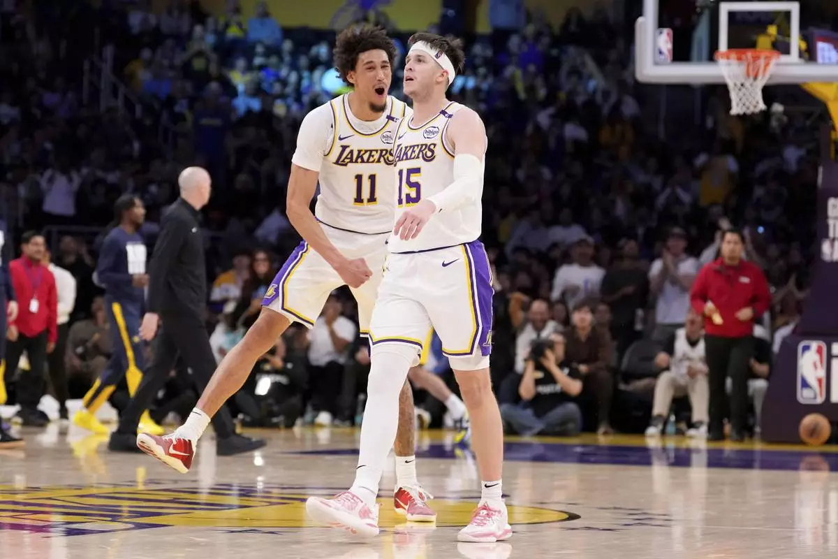Los Angeles Lakers guard Austin Reaves, right, celebrates with center Jaxson Hayes after scoring during the second half of an NBA basketball game against the Indiana Pacers, Saturday, Feb. 8, 2025, in Los Angeles. (AP Photo/Mark J. Terrill)