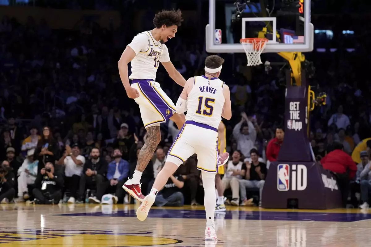 Los Angeles Lakers guard Austin Reaves, right, celebrates with center Jaxson Hayes after scoring during the second half of an NBA basketball game against the Indiana Pacers, Saturday, Feb. 8, 2025, in Los Angeles. (AP Photo/Mark J. Terrill)