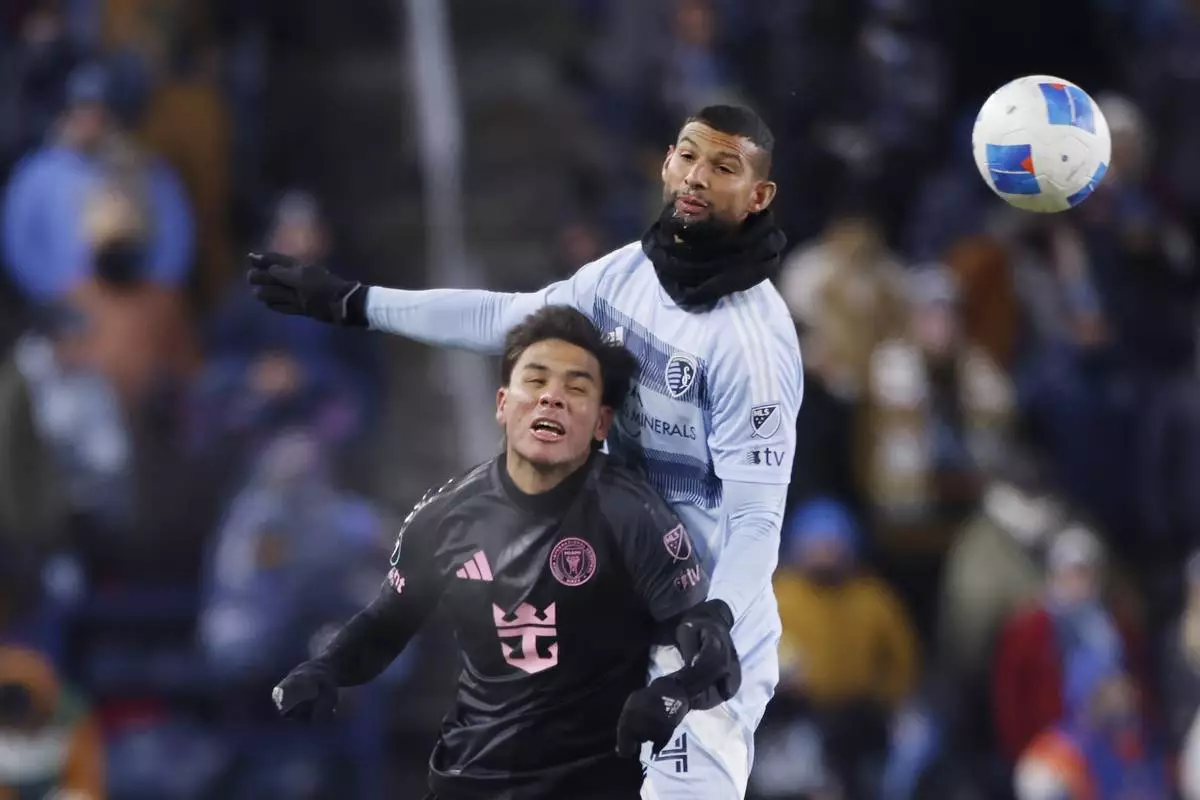 Inter Miami forward Leonardo Campana, left, and Sporting Kansas City defender Joaquín, right, go up for the ball during the second half of a CONCACAF Champions Cup soccer match, Wednesday, Feb. 19, 2025, in Kansas City, Kan. (AP Photo/Colin E. Braley)