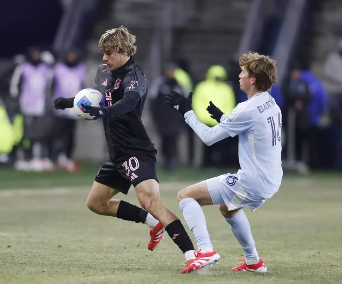 Inter Miami midfielder Benjamin Cremaschi (30) attempts to control a pass as Sporting Kansas City midfielder Jacob Bartlett (16) defends during the second half of a CONCACAF Champions Cup soccer match, Wednesday, Feb. 19, 2025, in Kansas City, Kan. (AP Photo/Colin E. Braley)
