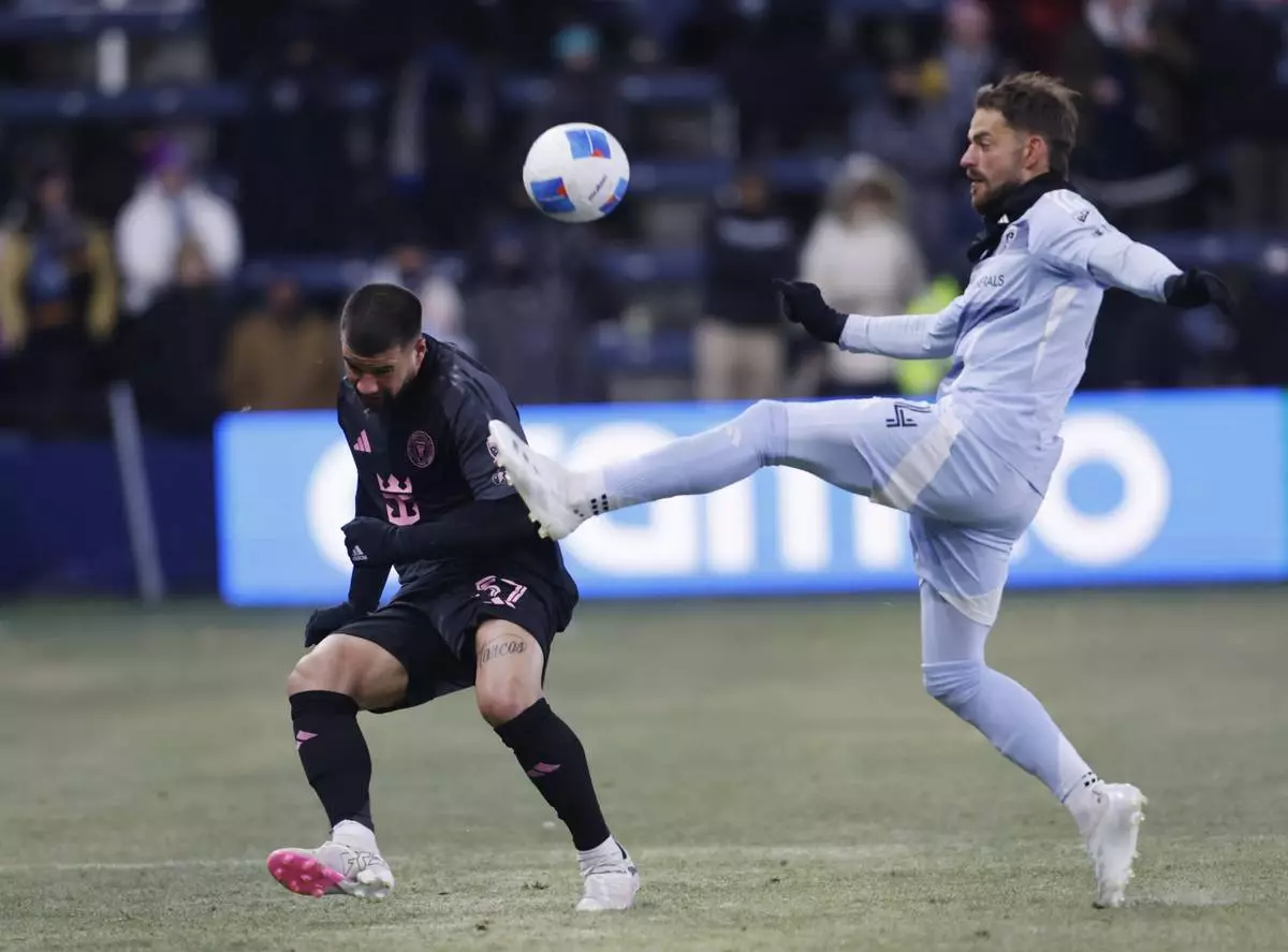 Sporting Kansas City defender Robert Voloder, right, clears the ball over Inter Miami defender Marcelo Weigandt during the first half of a CONCACAF Champions Cup soccer match, Wednesday, Feb. 19, 2025, in Kansas City, Kan. (AP Photo/Colin E. Braley)