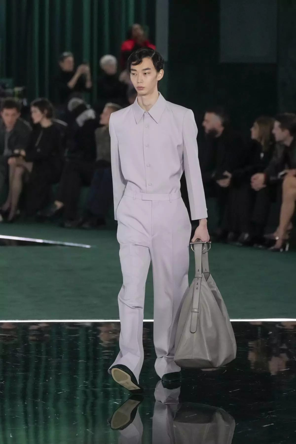 A model wears a creation as part of the Gucci Fall/Winter 2025-2026 men's and women's collection, presented in Milan, Italy, Tuesday, Feb. 25, 2025. (AP Photo/Luca Bruno)