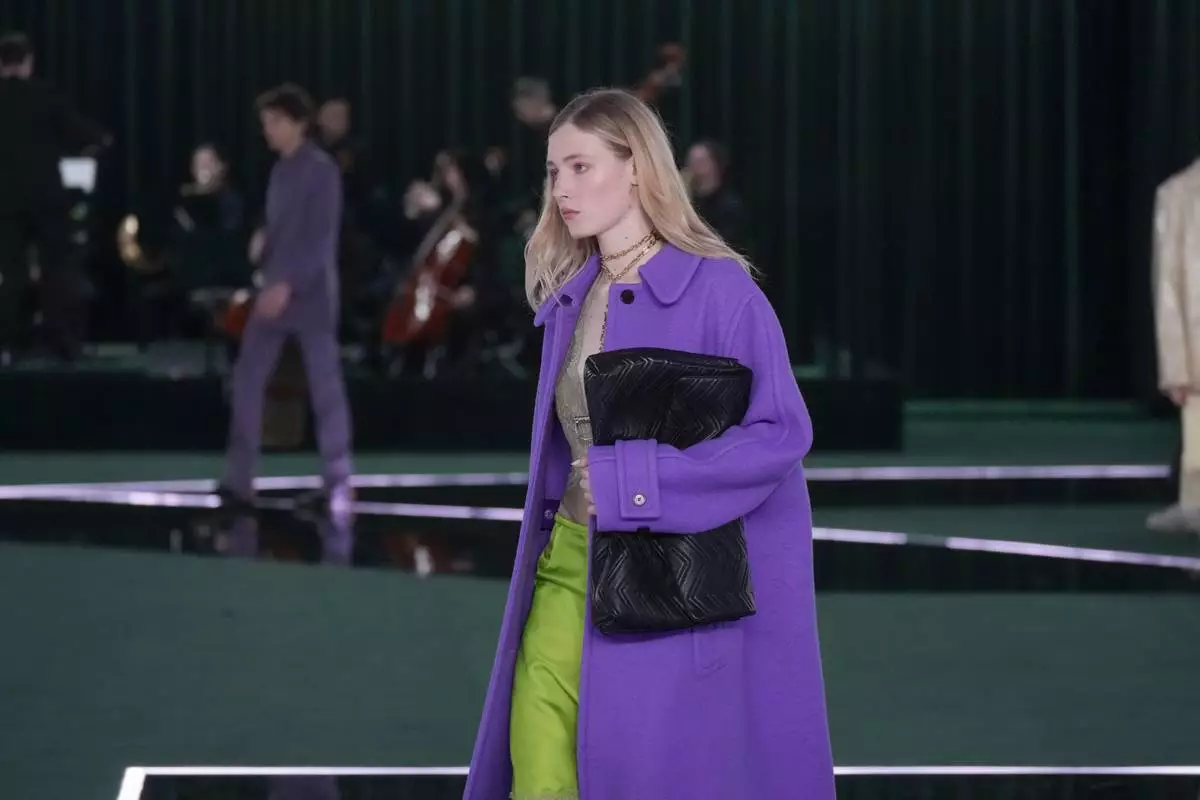 A model wears a creation as part of the Gucci Fall/Winter 2025-2026 men's and women's collection, presented in Milan, Italy, Tuesday, Feb. 25, 2025. (AP Photo/Luca Bruno)