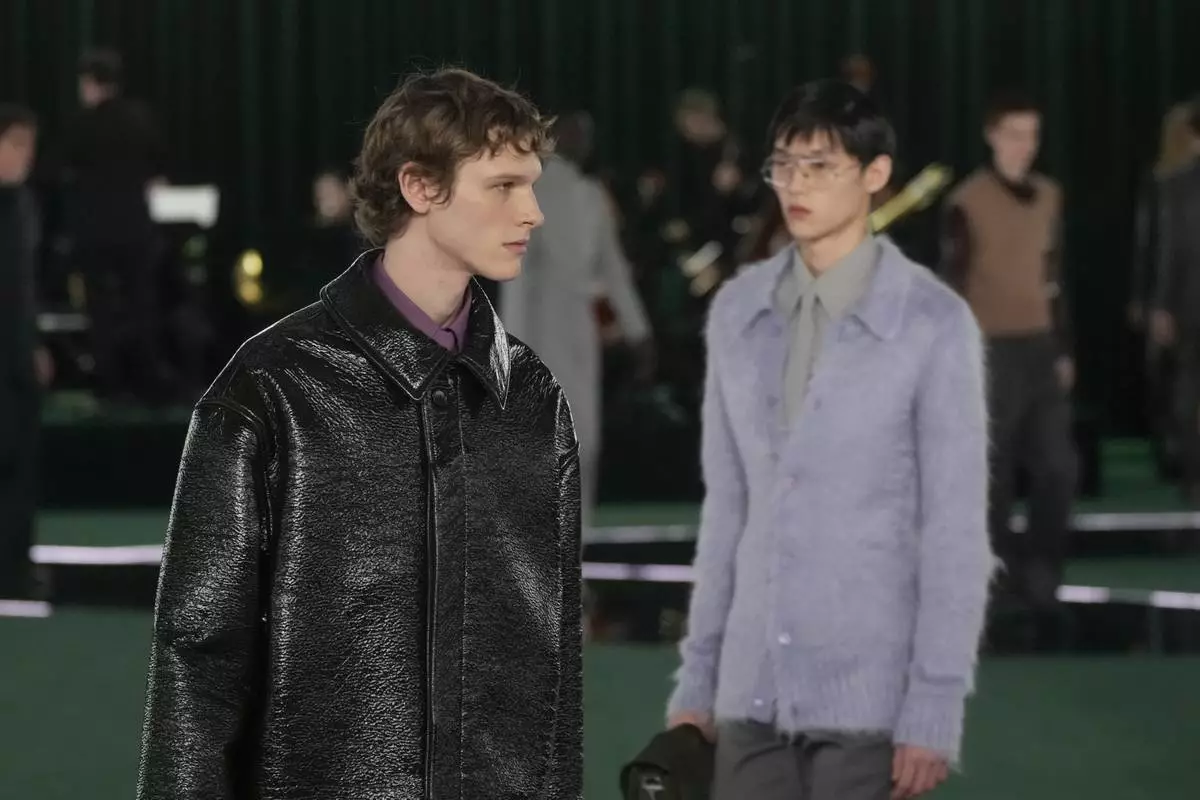 A model wears a creation as part of the Gucci Fall/Winter 2025-2026 men's and women's collection, presented in Milan, Italy, Tuesday, Feb. 25, 2025. (AP Photo/Luca Bruno)