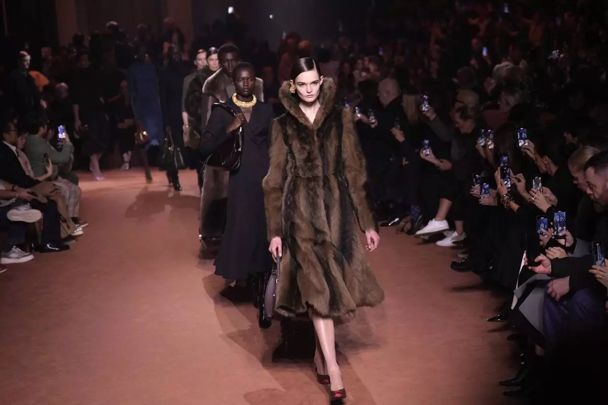 Models wear creations of the Fendi Fall/Winter 2025-2026 women's collection presented in Milan, Italy, Wednesday, Feb. 26, 2025. (AP Photo/Luca Bruno)