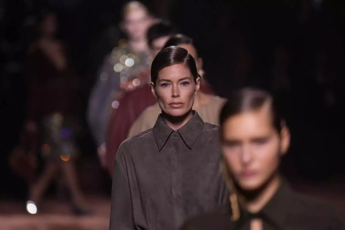 Models wear creations of the Fendi Fall/Winter 2025-2026 women's collection presented in Milan, Italy, Wednesday, Feb. 26, 2025. (AP Photo/Luca Bruno)