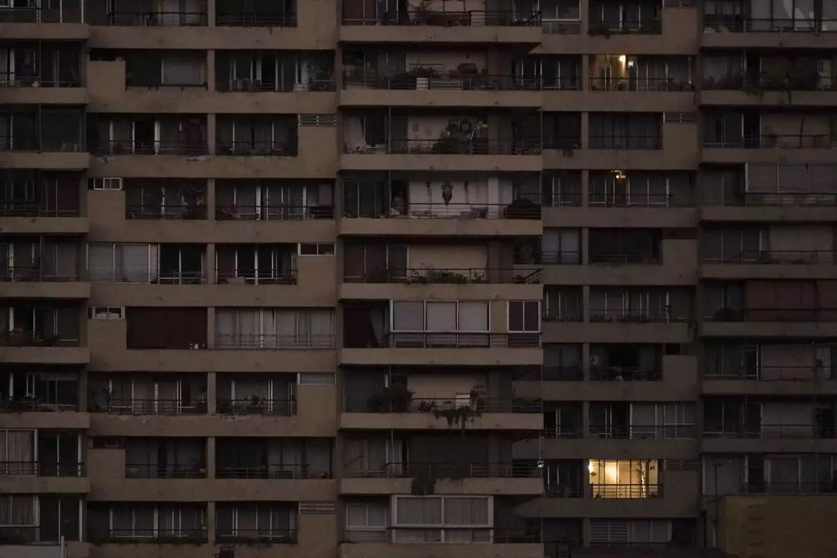 An apartment is illuminated the morning after power was restored from a nationwide blackout in Santiago, Chile, Wednesday, Feb. 26, 2025. (AP Photo/Matias Basualdo)