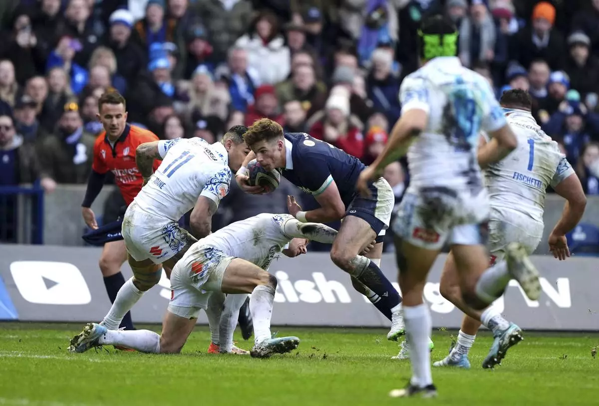 Scotland's Huw Jones on his way to scoring his third try during the Six Nations rugby union match between Scotland and Italy, at Murrayfield Stadium, Edinburgh, Scotland, Saturday Feb. 1, 2025. (Andrew Milligan/PA via AP)