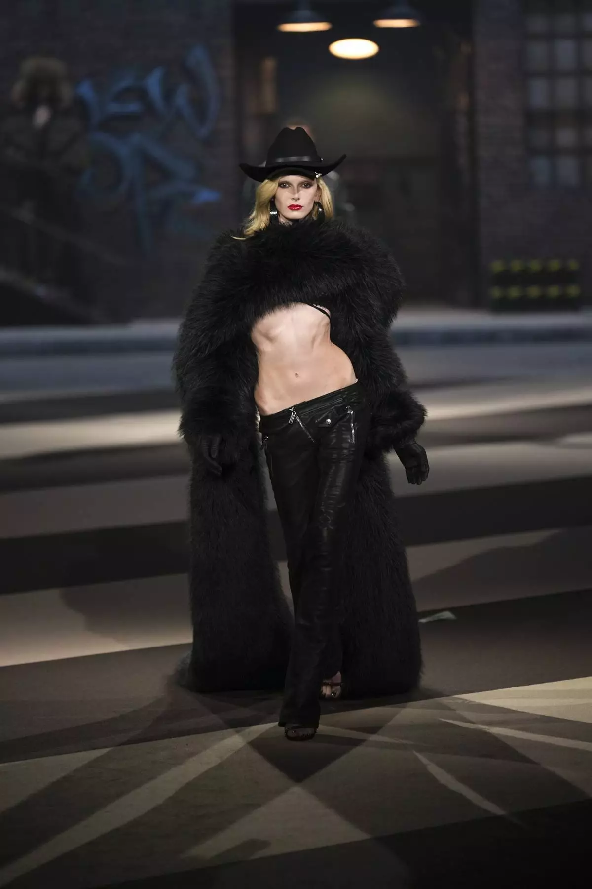 A model wears a creation as part of the Dsquared2 Fall/Winter 2025-2026 men's and women's collection presented in Milan, Italy, Tuesday, Feb. 25, 2025. (AP Photo/Antonio Calanni)