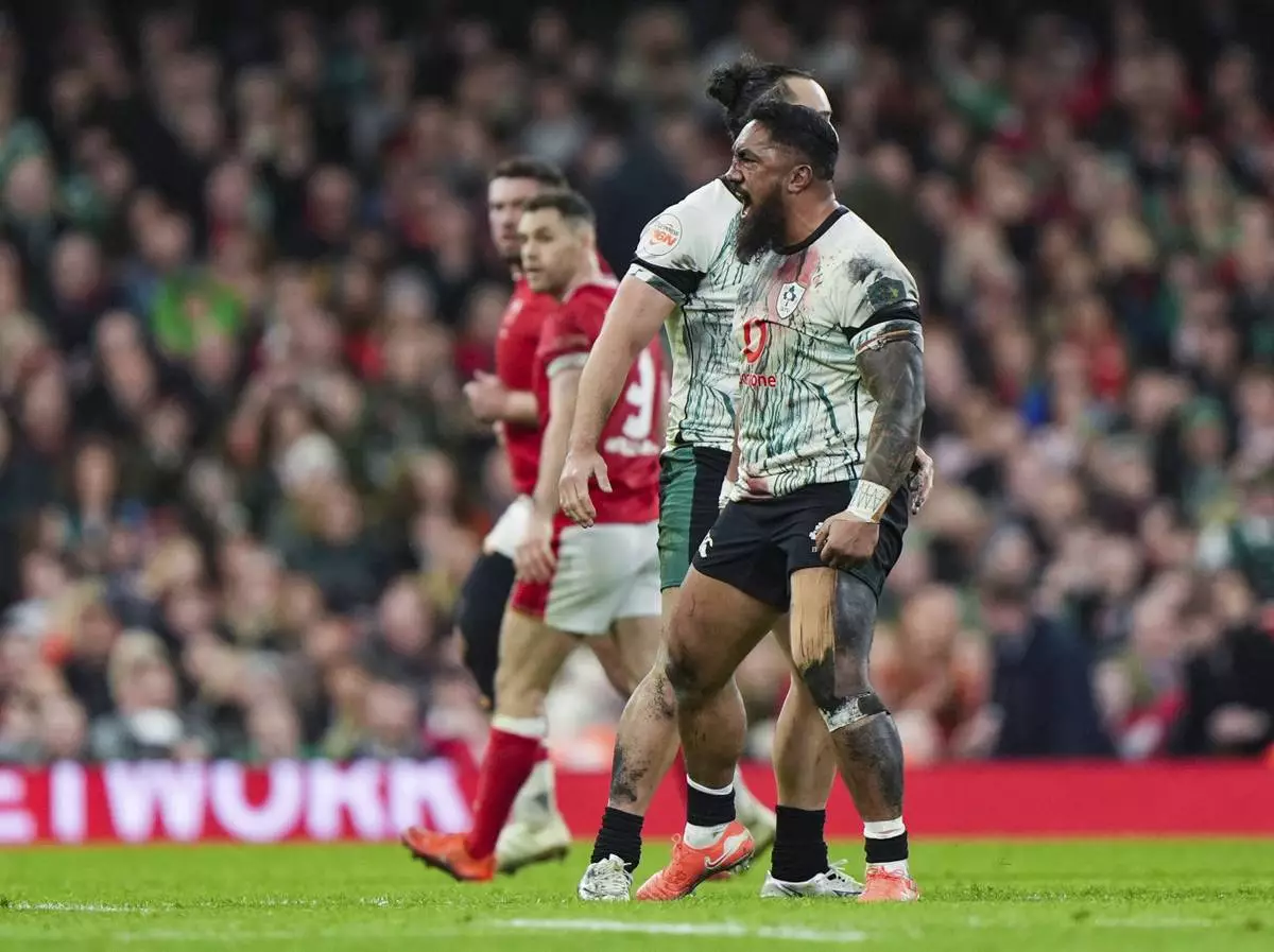 Ireland's James Lowe and Bundee Aki celebrates winning a penalty, during the Six Nations rugby match between Wales and Ireland, at the Principality Stadium, in Cardiff, Wales, Saturday, Feb. 22, 2025. (Joe Giddens/PA via AP)