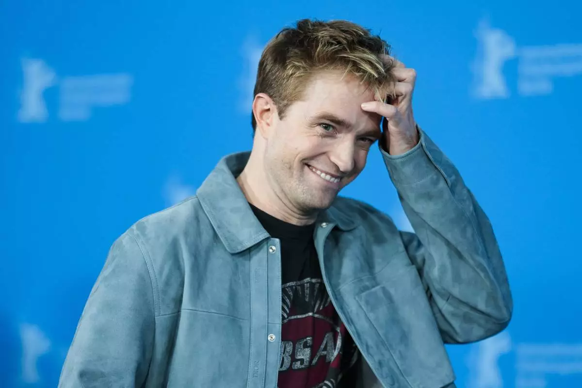 Robert Pattinson poses for photographer at the photo call for the film 'Mickey 17' at the International Film Festival, Berlinale, in Berlin, Saturday, Feb. 15, 2025. (AP Photo/Markus Schreiber)