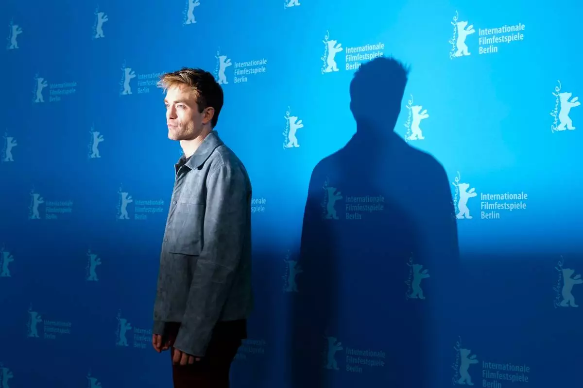 Robert Pattinson poses for photographer at the photo call for the film 'Mickey 17' at the International Film Festival, Berlinale, in Berlin, Saturday, Feb. 15, 2025. (AP Photo/Markus Schreiber)