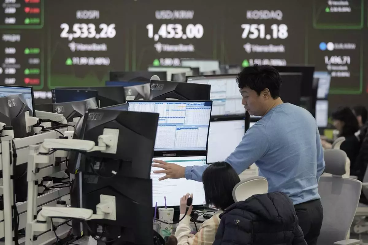 Currency traders watch monitors at the foreign exchange dealing room of the KEB Hana Bank headquarters in Seoul, South Korea, Tuesday, Feb. 11, 2025. (AP Photo/Ahn Young-joon)