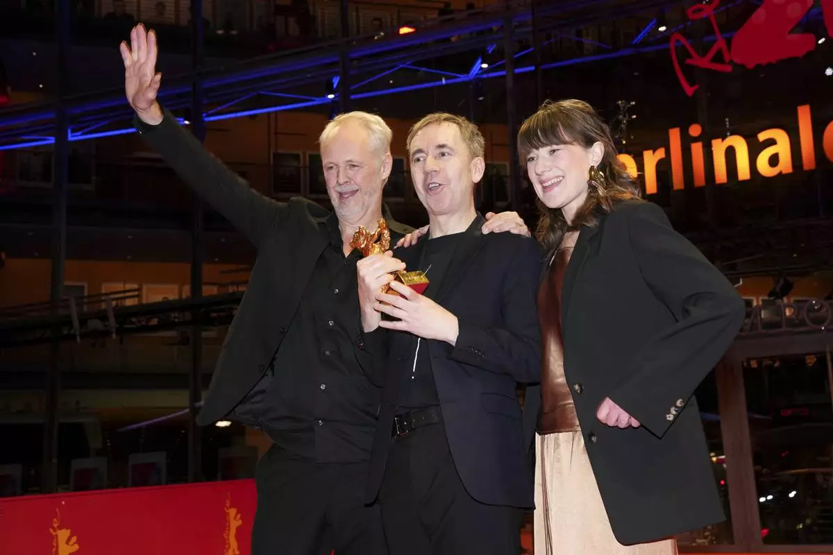 Yngve Saether, from left, Dag Johan Haugerud and Hege Hauff Hvattum, winners of the Golden Bear for best film for 'Dreams (Sex Love)', pose for photographers at the winners photo call during the International Film Festival, Berlinale, in Berlin, Saturday, Feb. 22, 2025. (Photo by Scott A Garfitt/Invision/AP).