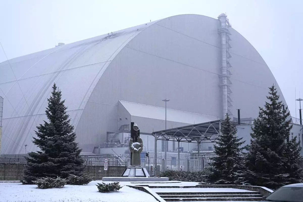 A view of the containment vessel that protects the remains of reactor number four at the former Chernobyl nuclear power plant and built to contain radiation, after a drone attack, Ukraine, Friday, Feb. 14, 2025. (AP Photo/Efrem Lukatsky)