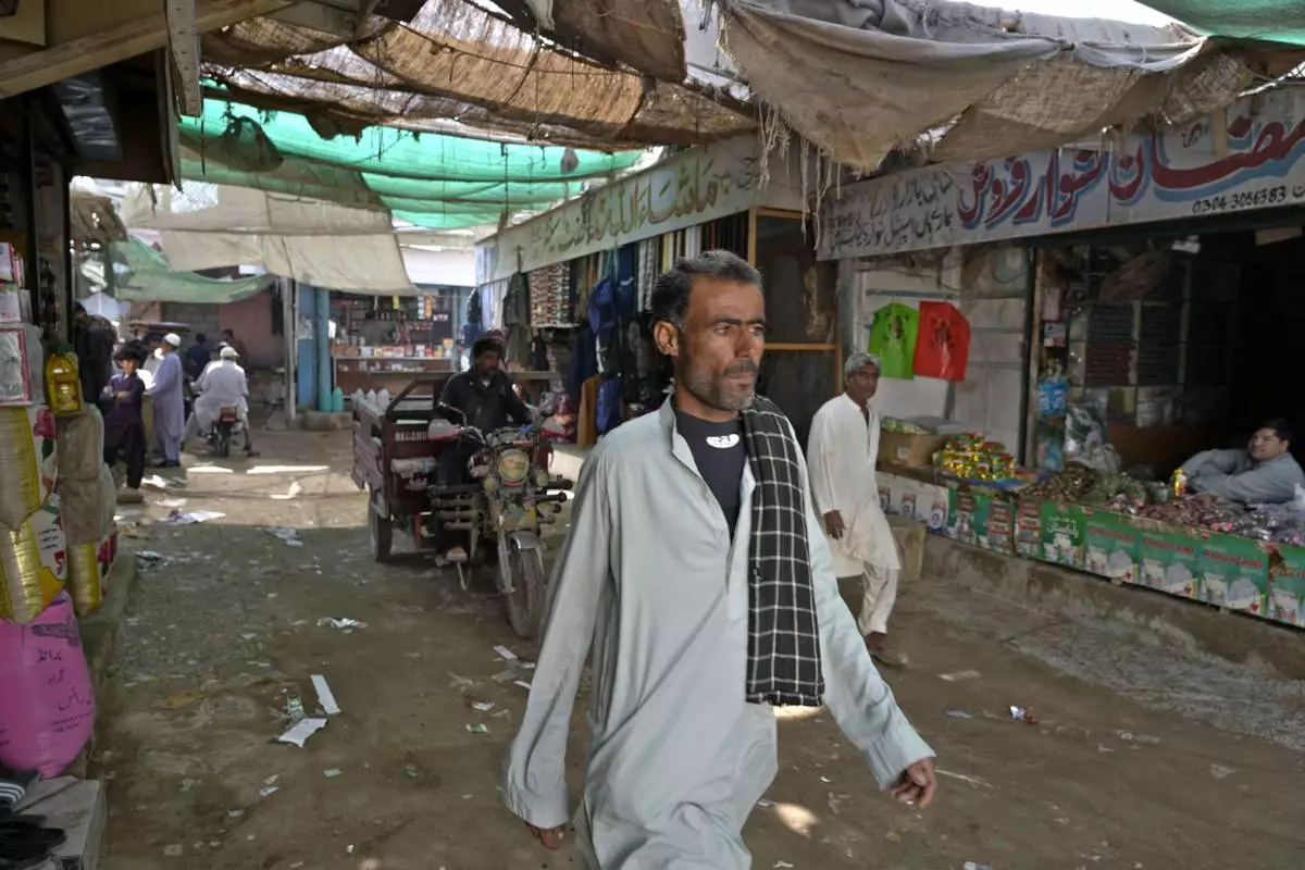 People walk through a market in the coastal city of Gwadar, in the southwest Pakistani province of Balochistan, Jan. 13, 2025. (AP Photo/Anjum Naveed)