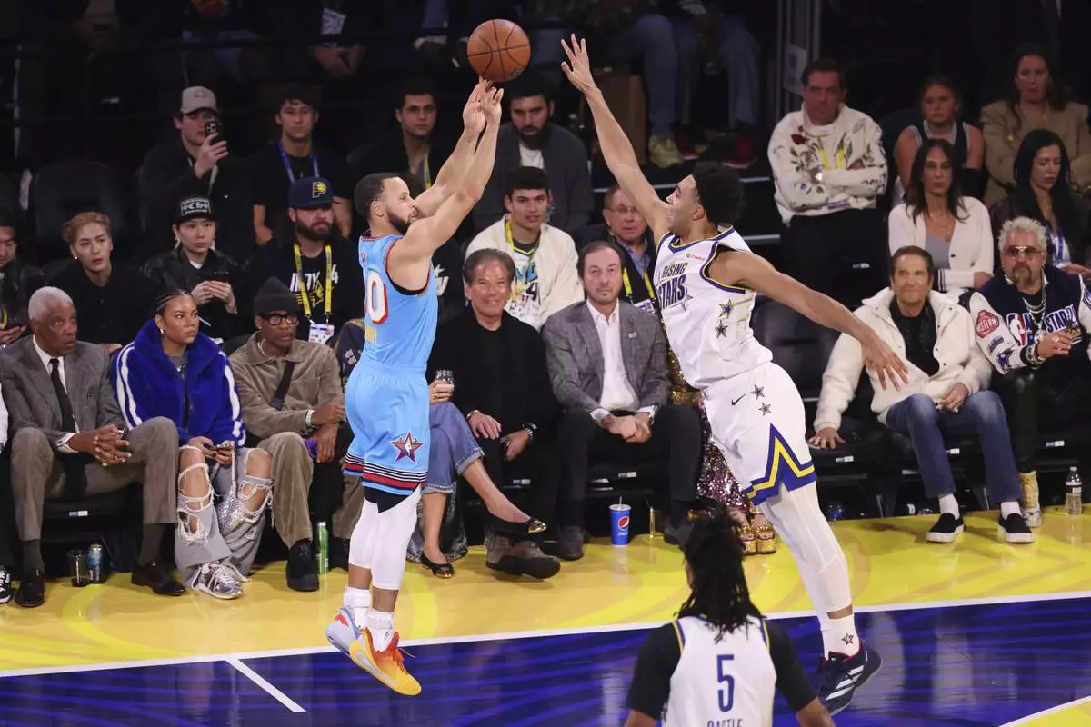 Golden State Warriors guard Stephen Curry makes a 3-point basket during the NBA All-Star basketball game Sunday, Feb. 16, 2025, in San Francisco. (AP Photo/Jed Jacobsohn)