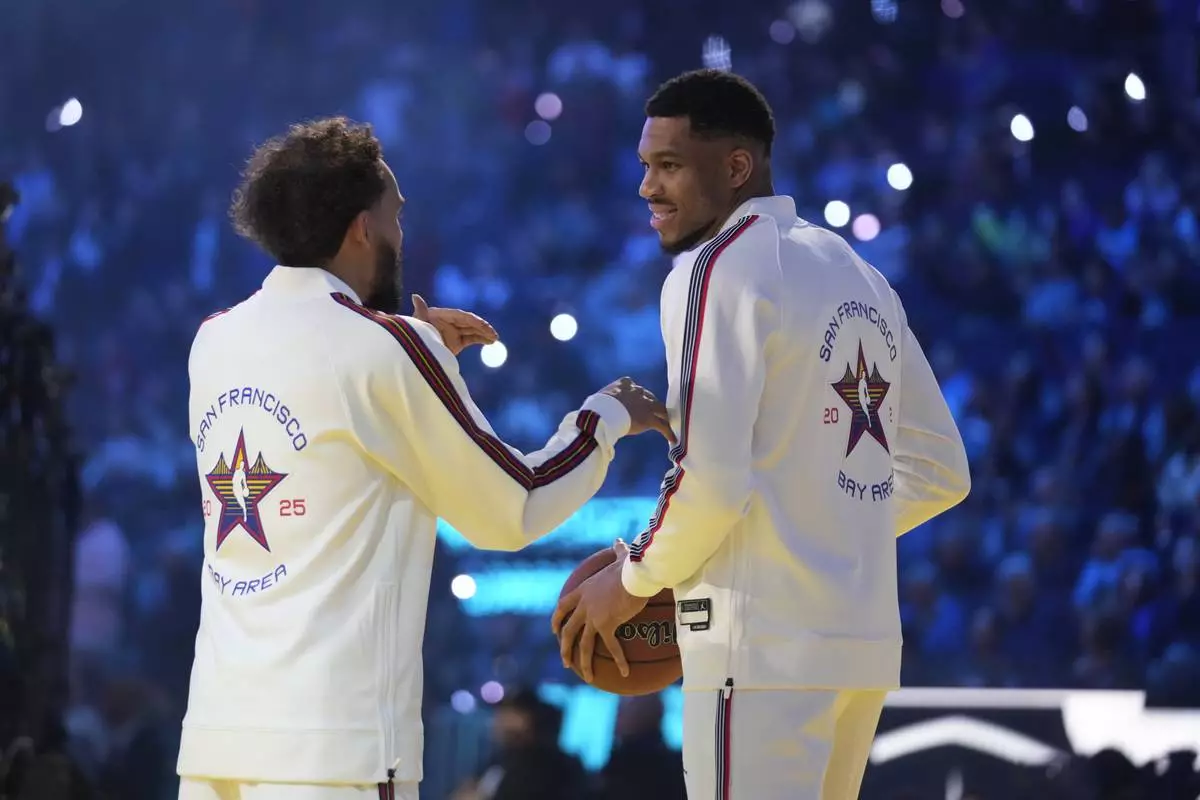 Milwaukee Bucks center Giannis Antetokounmpo talks to Atlanta Hawks guard Trae Young during the NBA All-Star basketball game Sunday, Feb. 16, 2025, in San Francisco. (AP Photo/Godofredo A. Vásquez)