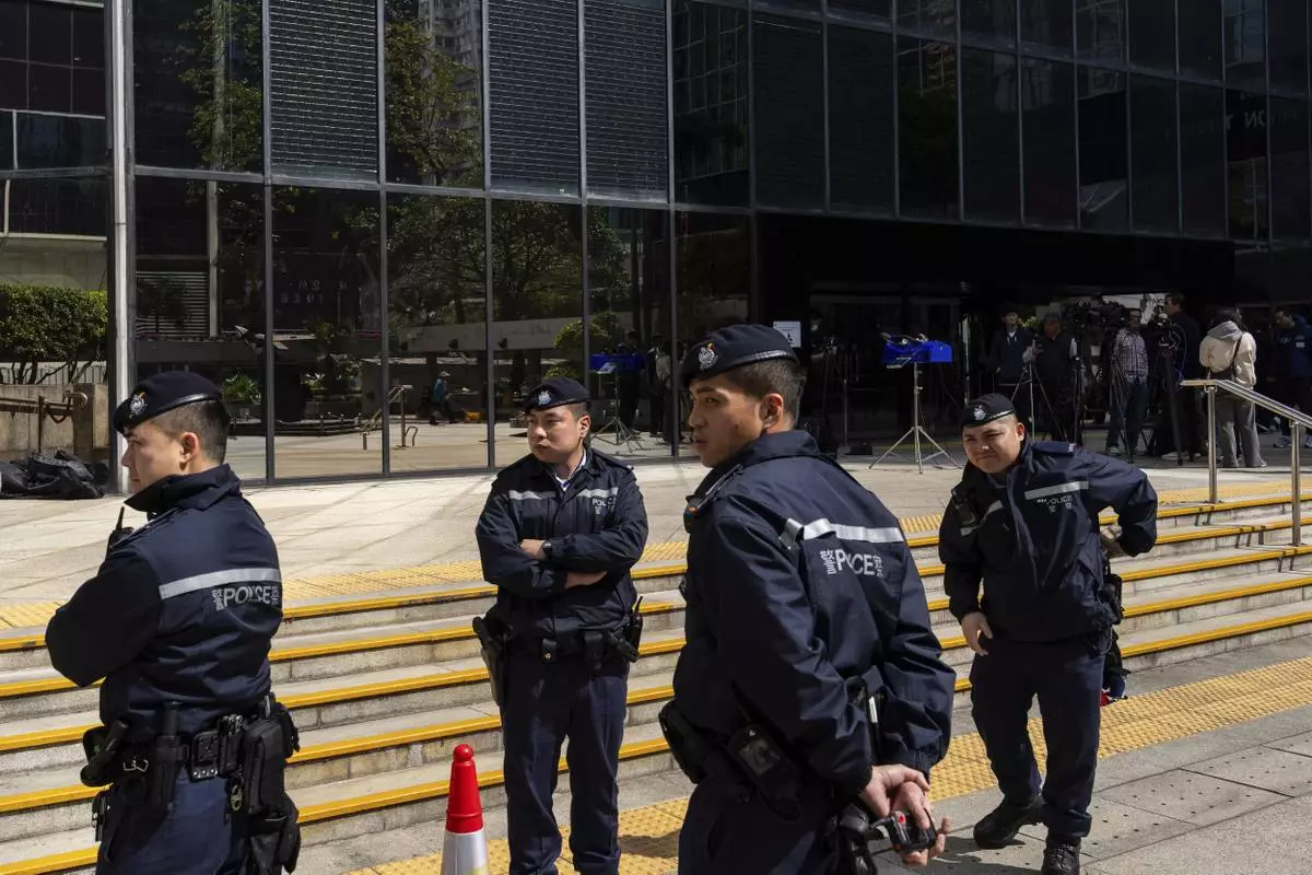 CORRECTS THE YEAR - Police officers stand guard outside the District Court ahead of the sentencing on a riot case involving a former pro-democracy lawmaker Lam Cheuk-ting in Wan Chai, Hong Kong on Thursday, Feb. 27, 2025. (AP Photo/Chan Long Hei)