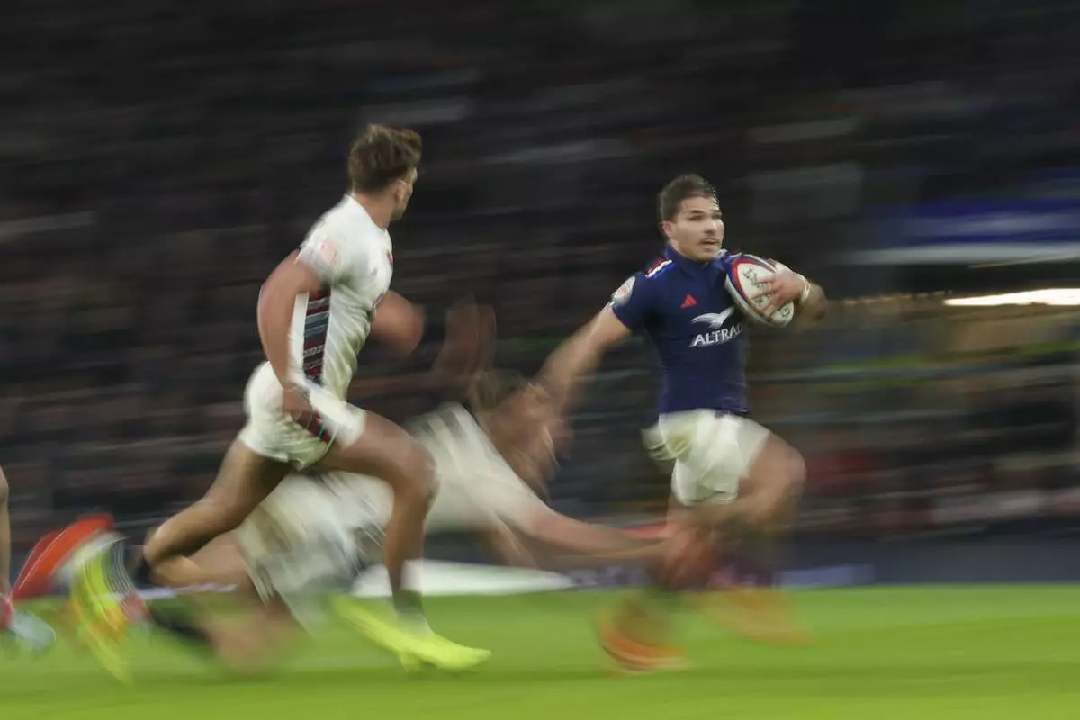 France's Antoine Dupont runs with the ball during the Six Nations rugby union match between England and France at Twickenham in London, Saturday, Feb. 8, 2025. (AP Photo/Ian Walton)