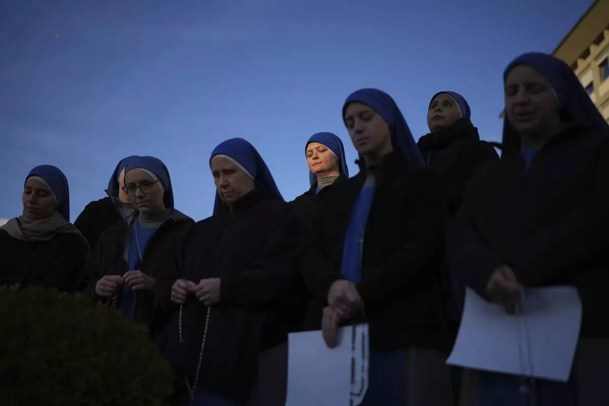 Nuns pray for Pope Francis in front of the Agostino Gemelli Polyclinic, in Rome, Saturday, Feb. 22, 2025, where the Pontiff is hospitalized since Friday, Feb. 14.(AP Photo/Alessandra Tarantino)