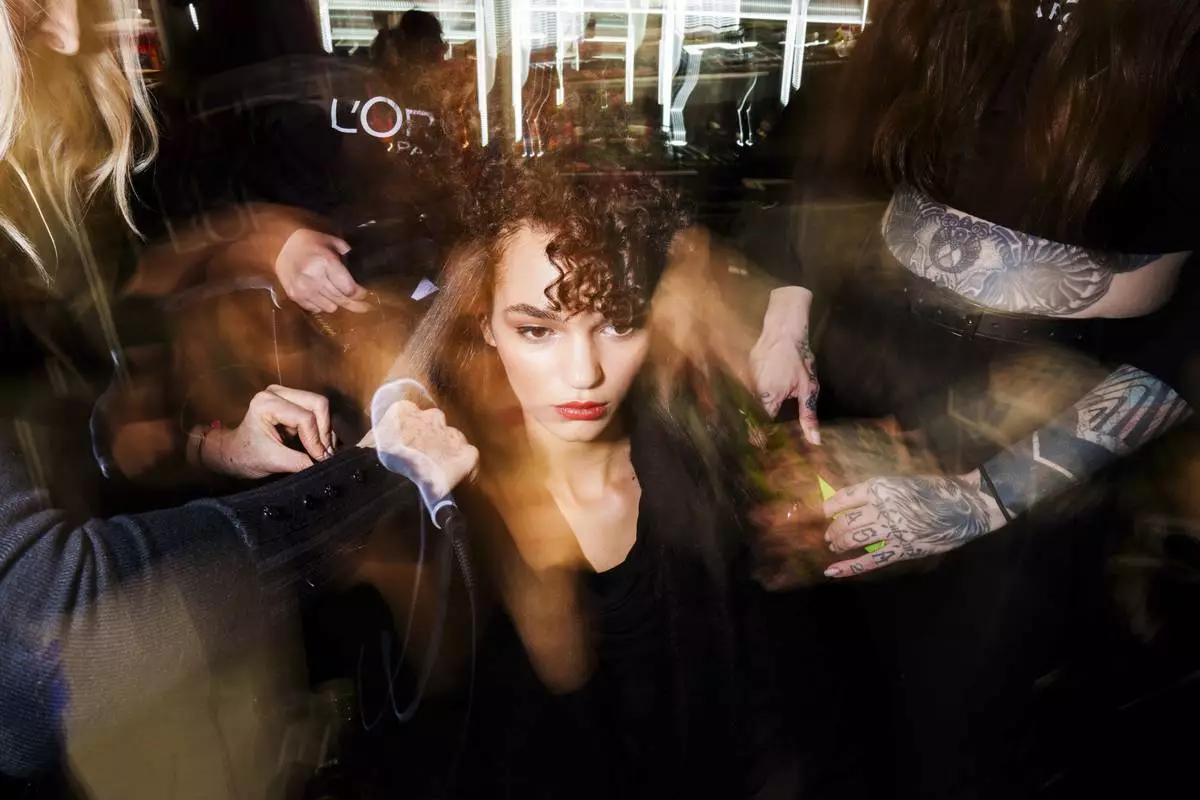 Makeup artists work backstage prior a fashion show at the Mercedes-Benz Fashion Week in Madrid, Friday, Feb. 21, 2025. (AP Photo/Bernat Armangue)