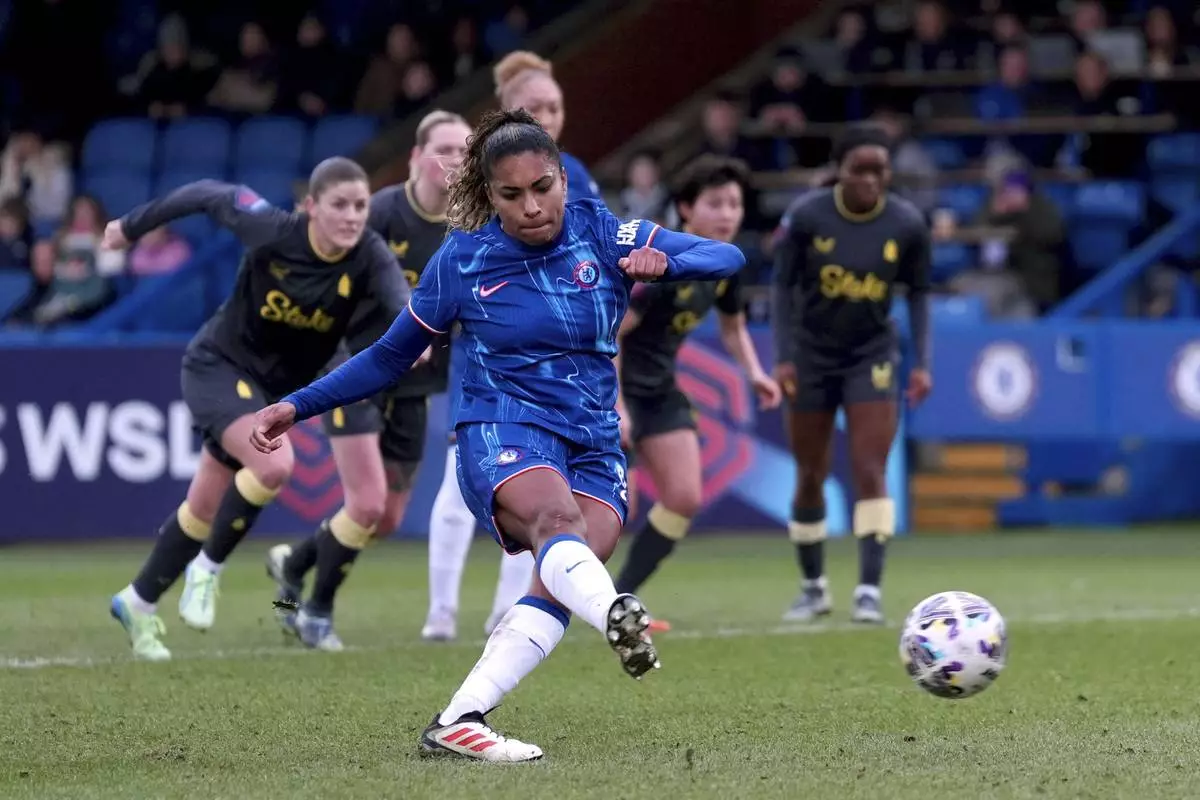 Chelsea's Catarina Macario scores their opening goal from the penalty spot, during the Women's FA Cup fifth round soccer match between Chelsea Women and Everton Women at Kingsmeadow, in London, Sunday, Feb. 9, 2025. (Bradley Collyer/PA via AP)