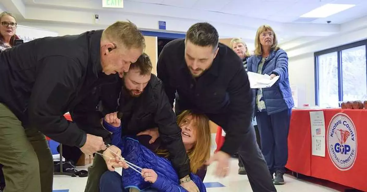 Idaho town hall meeting turns chaotic after woman is forcibly removed for shouting at speakers