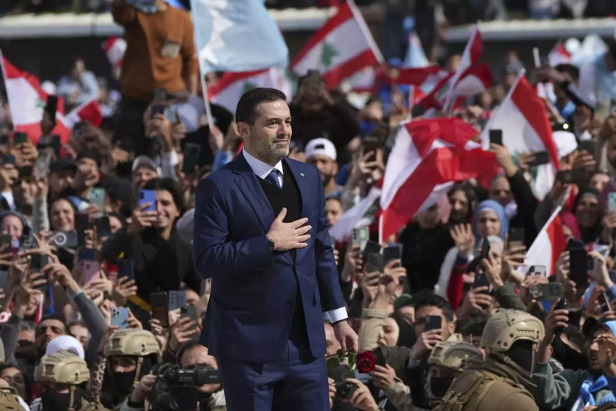Former Lebanese Prime Minister Saad Hariri greets his supporters after he paid his respects at the grave of his father, former Prime Minister Rafik Hariri, on the 20th anniversary of his assassination in Beirut, Lebanon, Friday, Feb. 14, 2025. (AP Photo/Hassan Ammar)